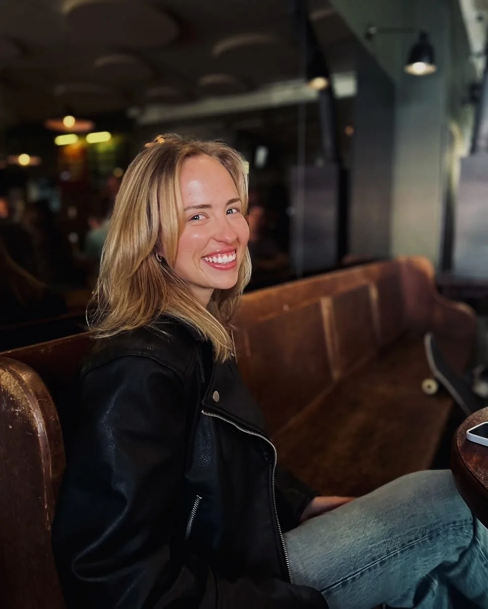 Tennielle Wynne seated in a café, wearing a black leather jacket